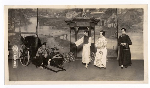 Man and two women negotiate with two rickshaw drivers, staged at the Mandarin Theater /