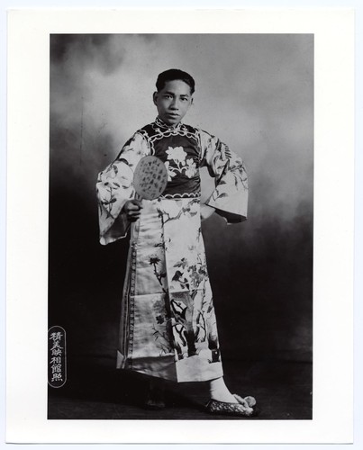 Portrait of an actor as a young scholar in modern dress with fan /