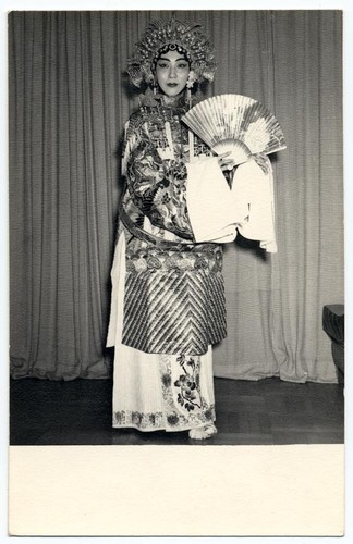 Actress portraying imperial concubine Yang Kuei-fei in The drunken beauty holding a peony fan /