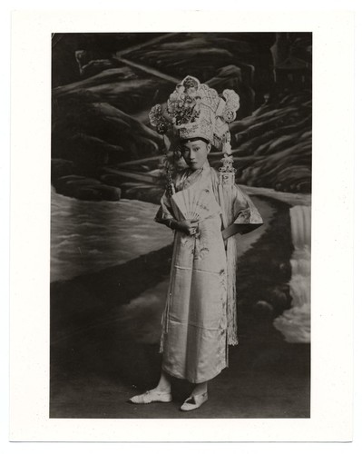 Actress in the role of scholar in classical gown with ornate head-dress /