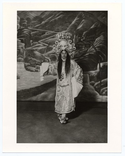 Chan Siew Chuen in role of warrior or gallant wearing bloused top boots and pheasant plumed headdress /