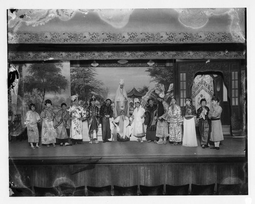 Ensemble of actors in a play with Kwan Yin, goddess of mercy at the Great Star Theatre /