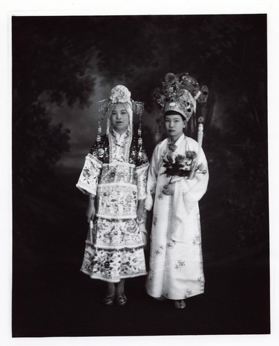 Scholar holding flowers holds hands with a woman in a scene from a romantic play /