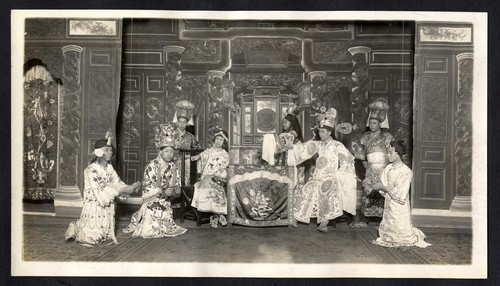 Three accused kneel before a judge and attendants pointing to another accused in handcuffs, possibly at the Great Star Theatre /