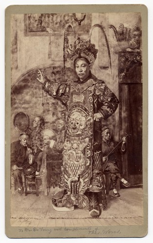 Photograph of a painting by Theodore Wores of a standing warrior with musicians in the background /