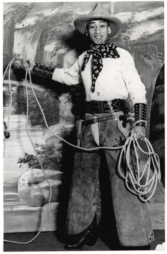 Cantonese opera actor Kwan Duk Hing plays a cowboy holding lasso in his hands in the 1930s/