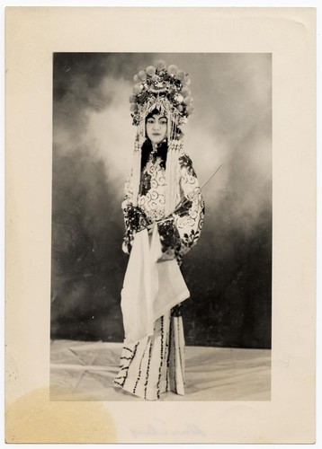 Actress standing and holding a sword /