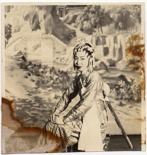 Seated actress with a sword on her back, possibly staged at the Great Star Theatre /