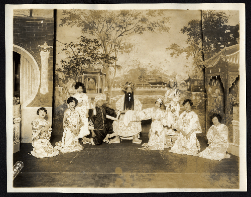 Dancing women entertain a court official in garden setting, staged at the Great Star Theatre /