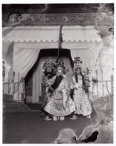 Kuan Yu, Kuan P'ing, his adopted son holding the offical seal and Chou Tsang, general and halberd bearer outside a military tent in the play "Flooding of plains in defeating P'ang Te Shui-lien ch'i-chun" /