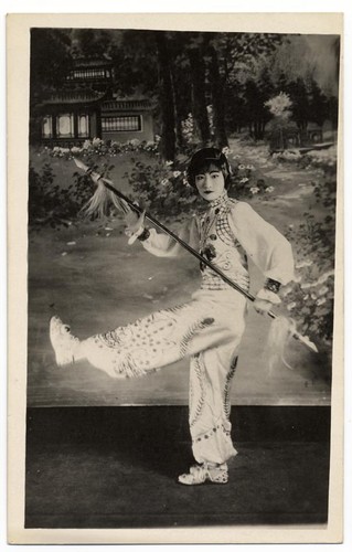 Actress in tan role dancing with a spear at the Great Star Theatre /