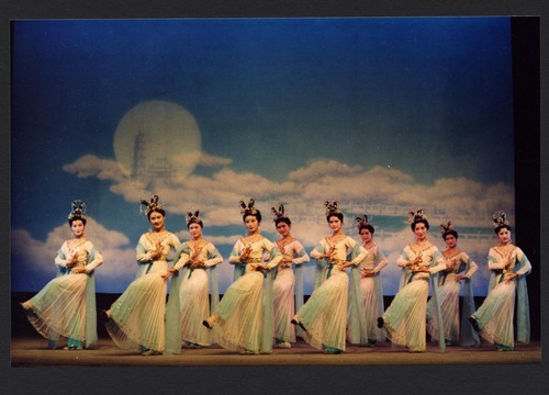 10 Chinese women dancing before dream scenery with clouds, moon, pagoda and tower /