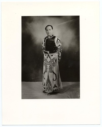 Actor standing dressed in a sleeveless short jacket and a sequinned ...