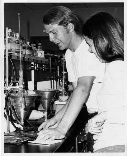 [Two students working in chemistry lab]