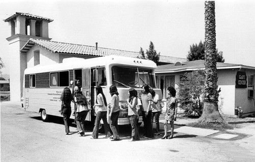 [Students entering sewing class in mobile unit]