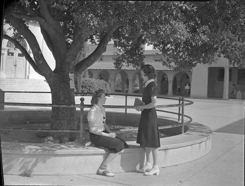 [Two female students in the quad]