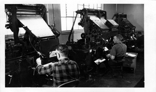 [Students operating linotype machines]