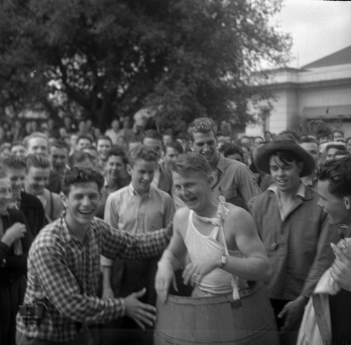 [Male student wearing barrel]