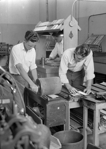 [Three students in print shop, 1932]