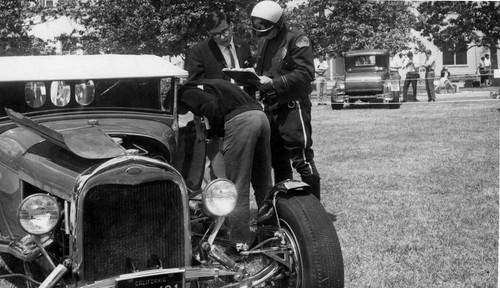 [Vintage cars and police officer on quad]