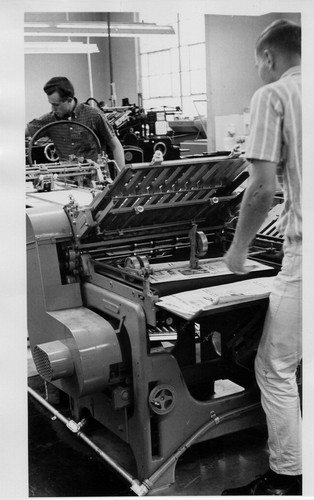 [Students operating a printing press]