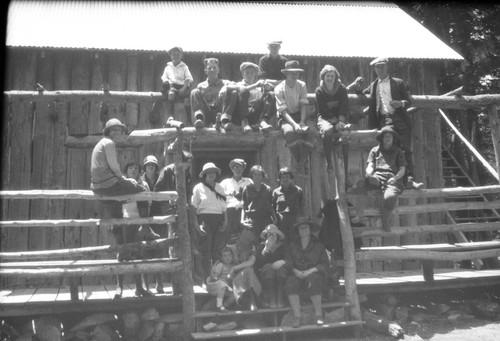 [Students posed on porch of mountain cabin]