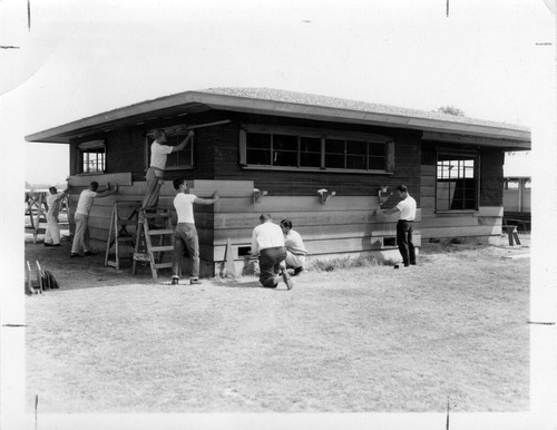 [Students building a house in construction class]