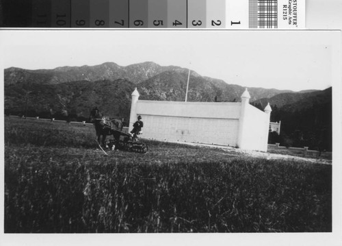 Leslie C. Brand mowing his landing strip for the private airport, circa 1922