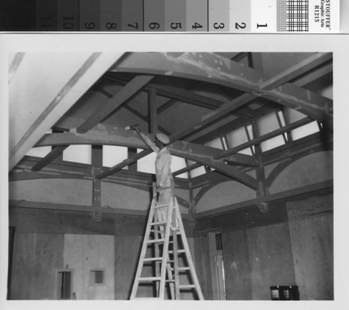 Workman painting in solarium during the 1950s Brand Library renovation