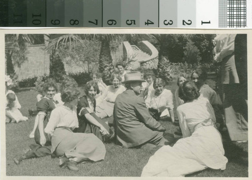 Man with circle of women at the lodge