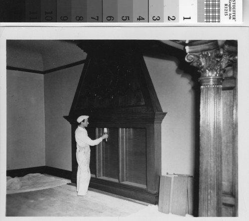Workman painting the fireplace during the 1950s Brand Library renovation