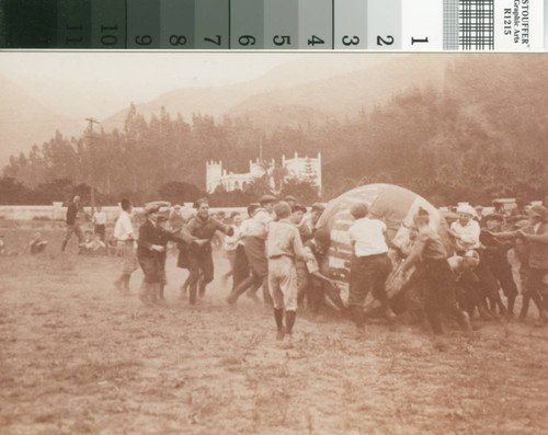 School boys playing on airfield lawn