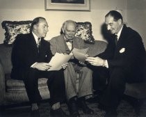 Dr. Lee de Forest reading with two men