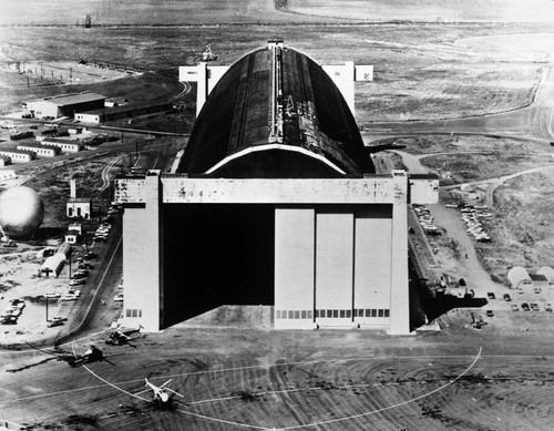 Aerial view of the Tustin MCAS blimp hangar and Tustin area, ca. 1960