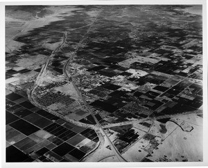 Aerial view of Indio, California, facing south by southeast, Route 111, Indio Boulevard, Indio High School, Indian Palms Country Club, County Center, fairgrounds, Date Festival