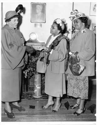 Chlora Hayes Sledge presents check to two women