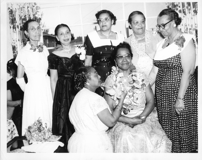 Woman placing ribbon on necklace of Stella A. Vick