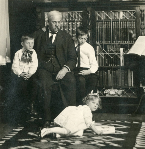 C. O. Barker and his three children; George, Omar Jr., and Carolyn in the parlor of their home on Murray Street in Banning, California
