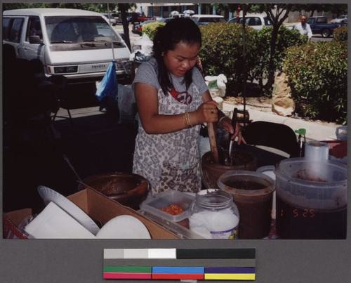 Woman making papaya salad on Refugee Day, Fresno, California