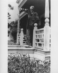 E. W. M. Evans standing on the porch of his home at 210 West Street, Petaluma, California, about 1924