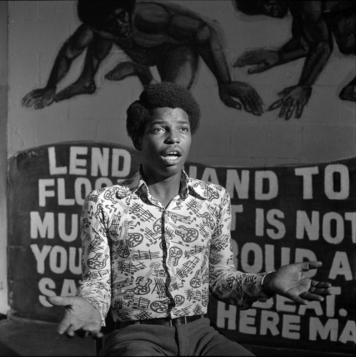 African American man sitting in front of a backdrop