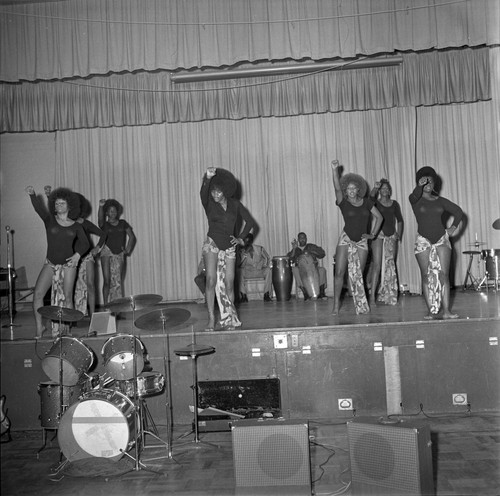 Dancers on stage with fists raised