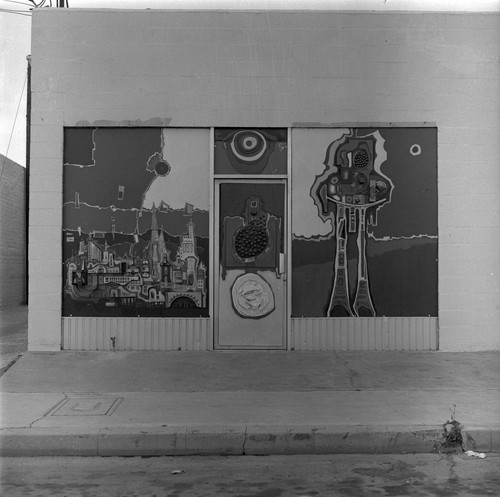 Left storefront door and windows of the Arena: 119 East Magnolia Street