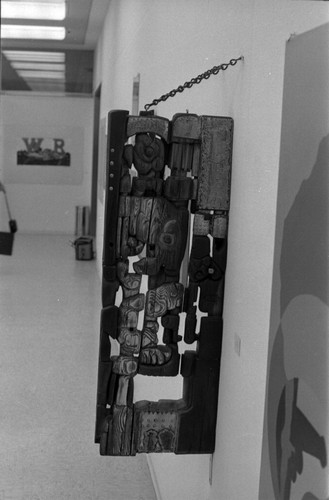 Wood sculpture mounted with a chain