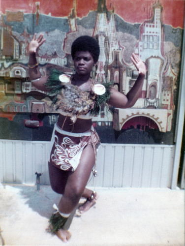 Dancer posing with both hands raised