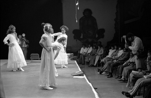 Fashion show with young girls in white dresses