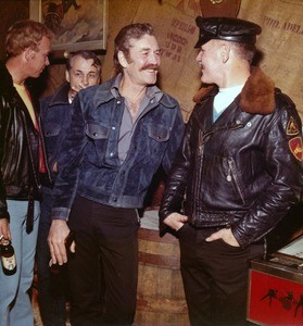 Men talking in bar wearing denim and leather