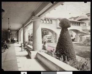 People relaxing on the porch of the Hotel Green, with the bridge to the hotel's annex just beyond them, ca.1900