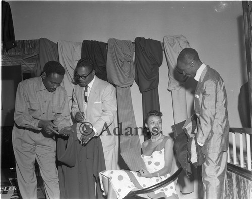 Men and women examine garments, Los Angeles, 1955