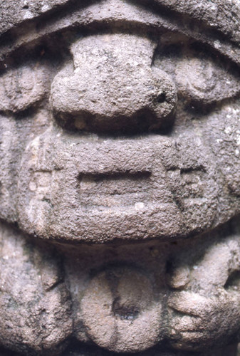Stone statue close-up, figure holding a snake, San Agustín, Colombia, 1975